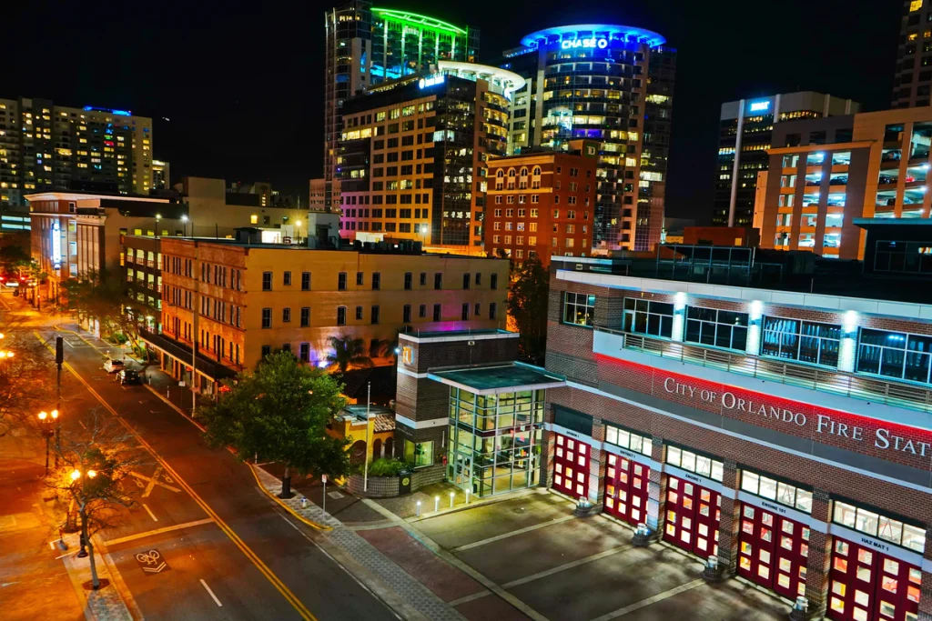 The city of Orlando at night. The fire hall is taking up a majority of the photo, pictured on the right.