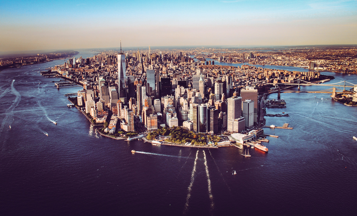 A cityscape along some water, where CFO advisory in NYC can be found in many of these tall buildings.