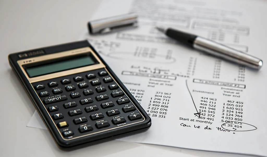 Materials a production accountant uses, such as a calculator and pen.