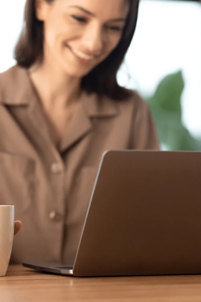 Detroit city tax return woman smiling at laptop