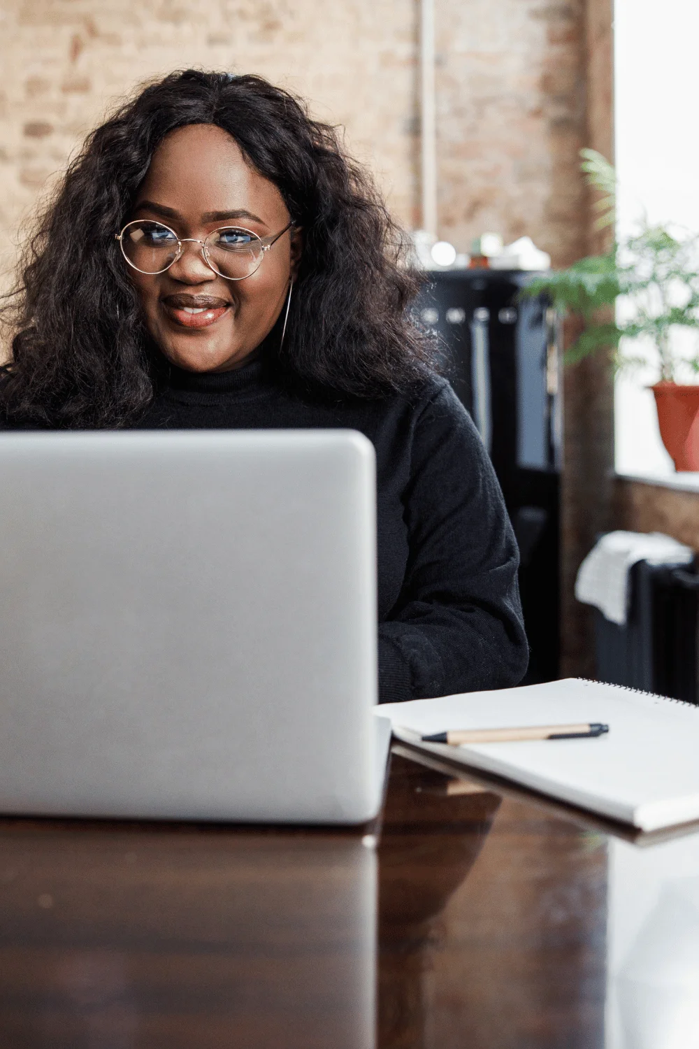 do you have to amend income tax returns for ERC woman with glasses smiling at laptop